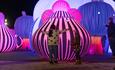 Kids hugging the inflatable Orchestra at night