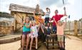 Family celebrating with their hands in the air after a fun day of crazy golf in Bournemouth
