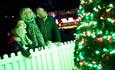 Family round lit up tree