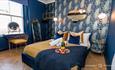 Dark Blue Master Bedroom with vanity Table and Mirror.