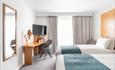 twin beds, desk and television
