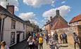 People walking up from Church Street towards the Priory