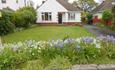 White exterior of modern bungalow with flowers