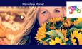 Woman smiling with sunflowers in her hands and food market in the background