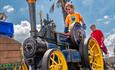Boy on a small steam engine