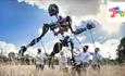A giant black puppet standing in a wheat field operating by 5 puppeteers in white t-shirts