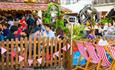 Beer garden packed with people with deck chairs outside