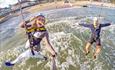 Two people going down the zipline