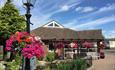 reception on a beautiful bright day with flowering hanging baskets
