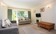 Lounge area with two sofas, flat screen TV and warm lights