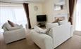 Warm open lounge with TV and fire place