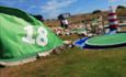 Close up image of a flag with the number 18 on it, with the course in the background.
