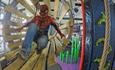 Kid dressed up as spiderman doing the course
