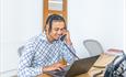 Estate Agent on the phone and a laptop